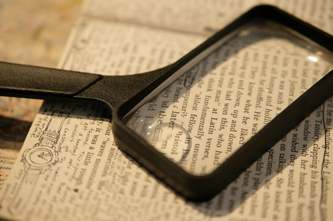magnifying glass on book